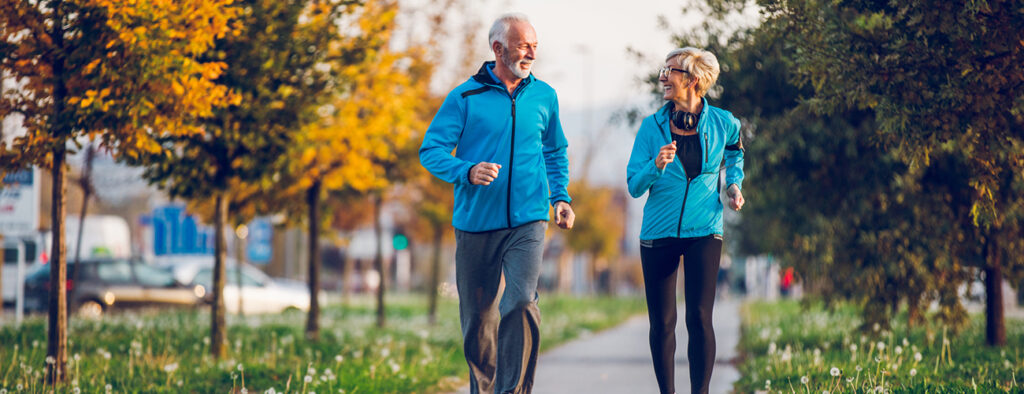 Senior Couple in Sports Clothing Jogging Together