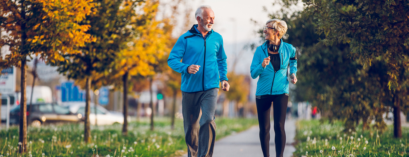 Senior Couple in Sports Clothing Jogging Together
