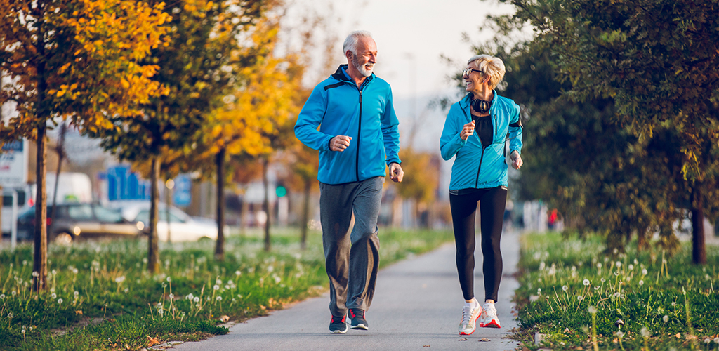 Senior Couple in Sports Clothing Jogging Together
